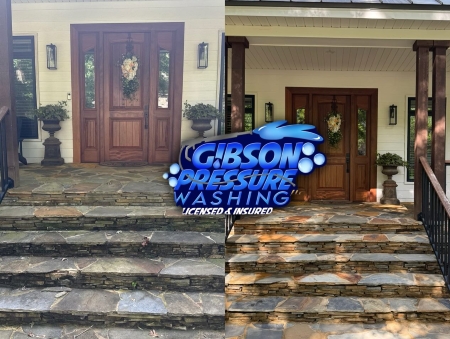 Pressure washing stone entry steps on an auburn property
